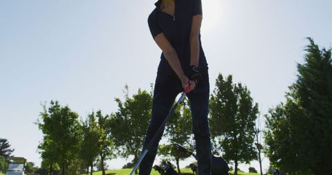 Senior golf enthusiast perfecting swing on sunny course