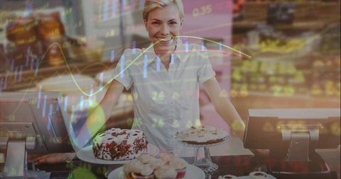 Smiling bakery owner presenting cakes at checkout counter with stock market data overlay