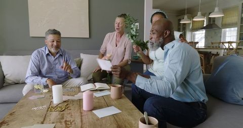 Diverse senior friends sharing gifts in cozy living room