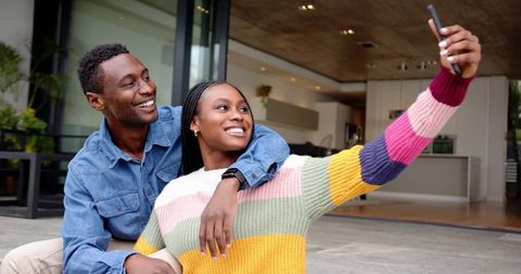 African American Couple Taking Selfie on Modern Patio