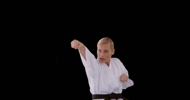 Female Martial Artist in White Gi Practicing Karate Punch - Download Free Stock Images Pikwizard.com