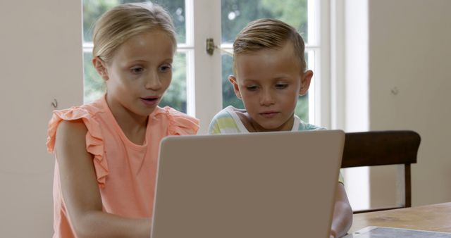 Siblings Using Laptop Together in Bright Home Interior - Download Free Stock Images Pikwizard.com