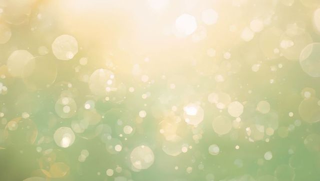 Dreamlike golden green bokeh backdrop with soft glowing orbs and ethereal light