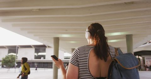 Woman Enjoying City Walk Wearing Headphones - Download Free Stock Images Pikwizard.com