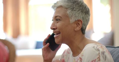 Happy Senior Woman Chatting on Phone at Home