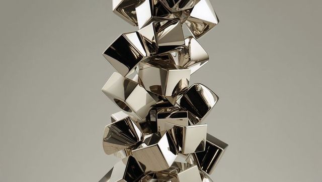 Reflective metallic cubes forming vertical abstract sculpture