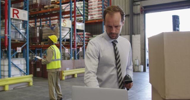 Warehouse Manager Using Laptop and Scanner Supervising Logistics - Download Free Stock Images Pikwizard.com