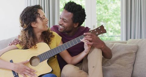 Couple Enjoying Time Together with Acoustic Guitar at Home