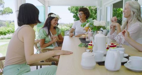Joyful Friends Conversing at Outdoor Wedding Celebration