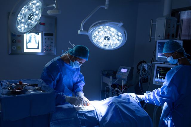 Surgeons performing operation in operation theater at hospital