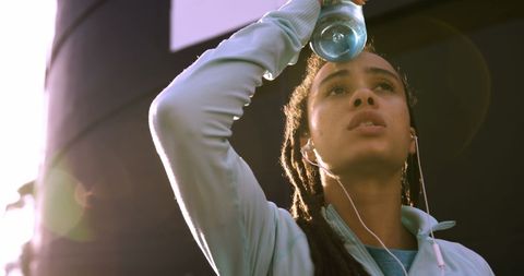 Tired Young Woman Refreshing After Urban Workout Break