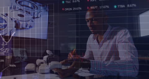 African American Businessman Analyzing Financial Data and Statistics