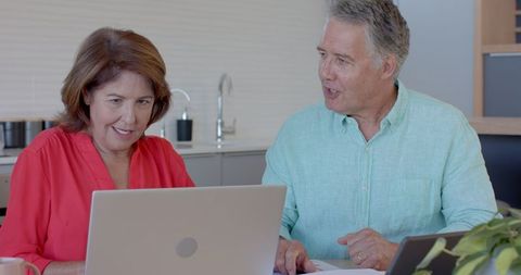 Senior Couple Enjoying Technology and Coffee at Home