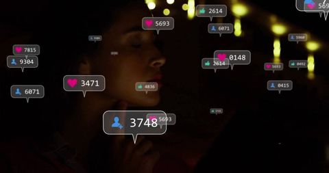 Woman Engaging with Digital Notifications from Laptop in Cozy Home Setting