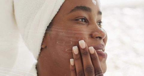 Woman Applying Skincare Product with Fingertips