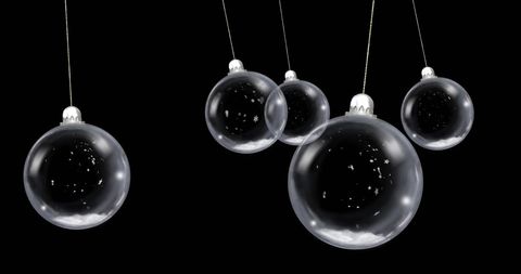 Floating Clear Christmas Baubles with Snowflakes Against Black