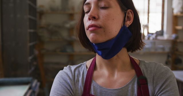 Female Artist Relaxing in Art Studio with Closed Eyes and Mask Around Neck - Download Free Stock Images Pikwizard.com