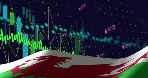 Welsh flag with red dragon rippling over financial trading chart showing market analytics