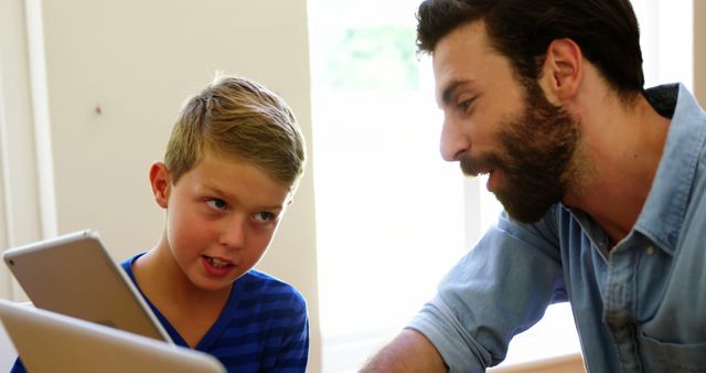 Father Helping Young Son with Homework on Tablet - Download Free Stock Images Pikwizard.com