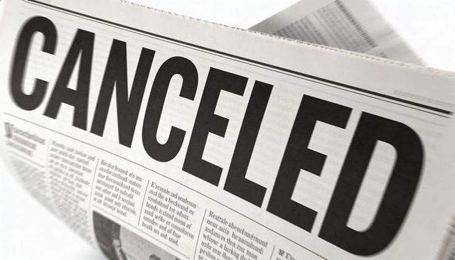 Bold canceled headline on folded newspaper conveying cancellation and breaking news