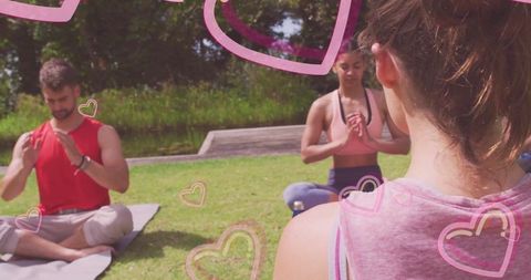 Group yoga practice on sunny lawn with relaxing atmosphere