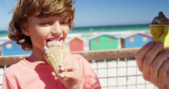 Joyful Child Eating Ice Cream at the Beach with Colorful Background - Download Free Stock Images Pikwizard.com