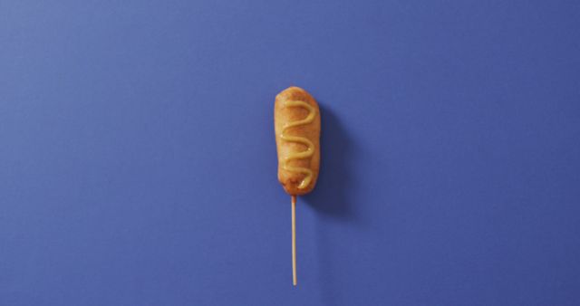 Corn Dog with Mustard on Bright Blue Background - Download Free Stock Images Pikwizard.com