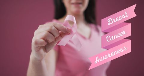 Woman Holding Pink Ribbon for Breast Cancer Awareness