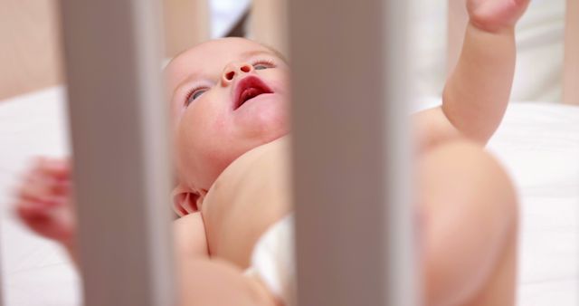 Baby Lying in Crib Looking Up Candid Moment - Download Free Stock Images Pikwizard.com