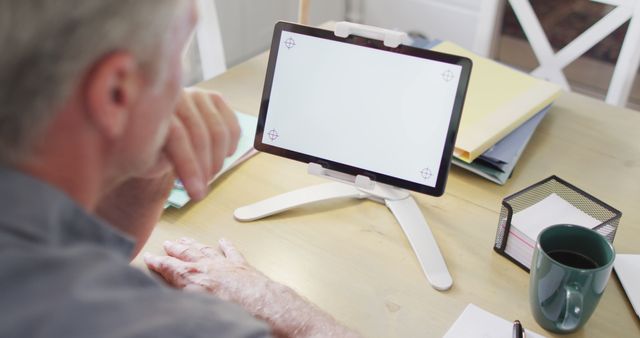 Senior Man Focusing on Digital Tablet at Home Office Table - Download Free Stock Images Pikwizard.com