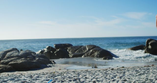 Calm Beach With Rocky Shoreline and Clear Sky - Download Free Stock Images Pikwizard.com