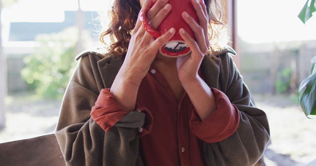 Woman with Curly Hair Holding Red Mug at Sunrise - Download Free Stock Images Pikwizard.com