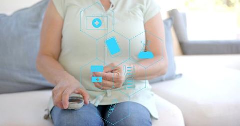 Middle-aged woman testing blood glucose at home with digital health icons