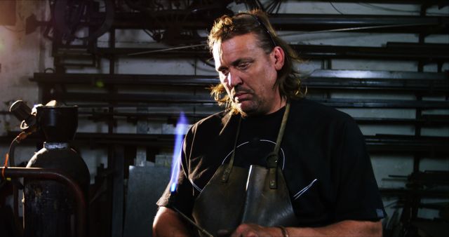 Male Metalworker Holding Welding Torch in Workshop, Concentrating - Download Free Stock Images Pikwizard.com