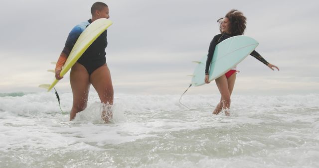 Joyful Female Surfers Enjoying Ocean Waves Together - Download Free Stock Images Pikwizard.com