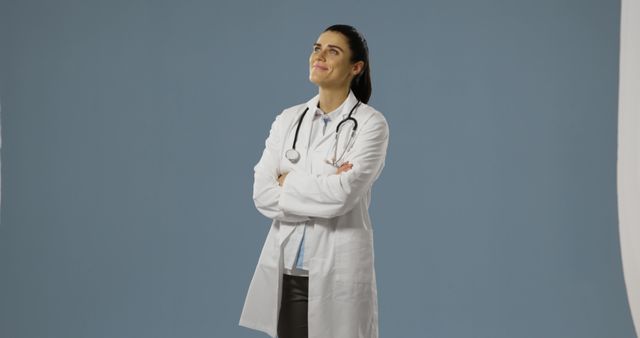 Confident Female Doctor with Stethoscope Looking Up - Download Free Stock Photos Pikwizard.com