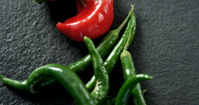 Close-up of Freshly Harvested Red and Green Chili Peppers on Dark Background - Download Free Stock Images Pikwizard.com