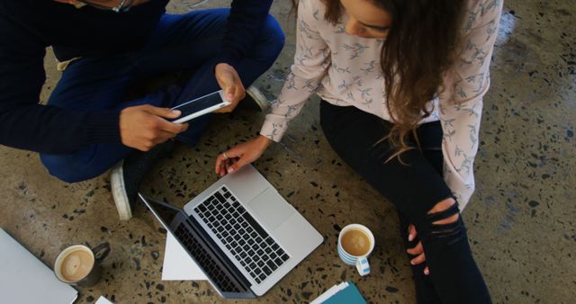 Creative Professionals Sitting on the Floor with Laptop and Coffee - Download Free Stock Images Pikwizard.com