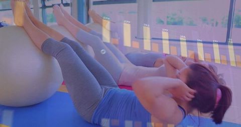 Women Exercising with Stability Balls in Modern Fitness Studio