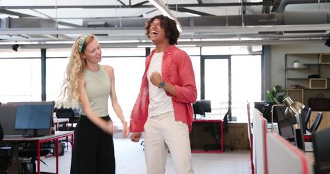 Joyful Colleagues Celebrating Success in Modern Office