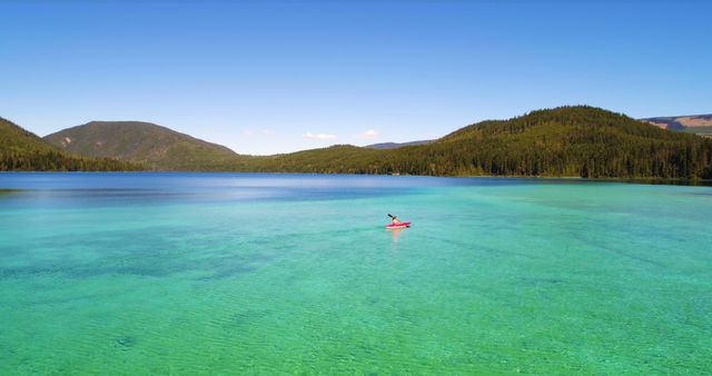 Serene Lake Vista with Solo Kayaker in Pristine Waters - Download Free Stock Images Pikwizard.com