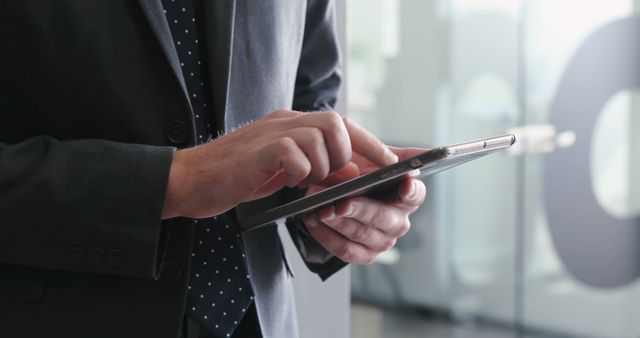 Focused Middle-aged Businessman Using Tablet, Professional Attire, Preparing for Meeting - Download Free Stock Images Pikwizard.com