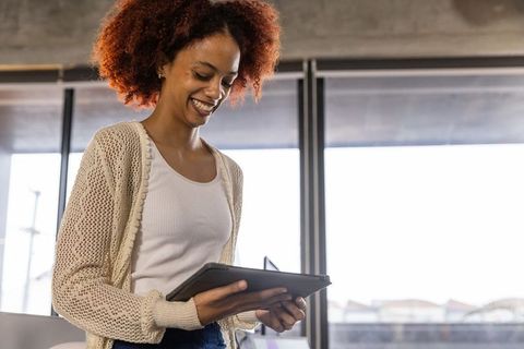 African American Woman Using Tablet in Modern Office Setting