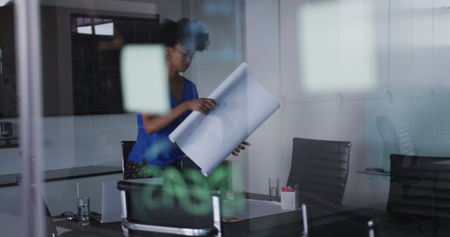 Businesswoman Reviewing Blueprints in Modern Office - Download Free Stock Images Pikwizard.com