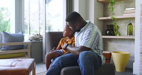 Father and Son Sharing Quality Time in Modern Living Room