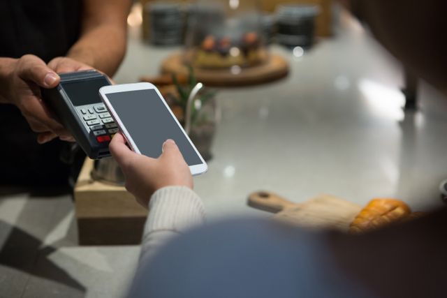 This image is ideal for illustrating modern payment methods in restaurants, highlighting the convenience and efficiency of contactless transactions. It can be used in articles about fintech, mobile payment solutions, or the future of cashless societies. It is also suitable for marketing materials for payment processing companies or technology blogs.