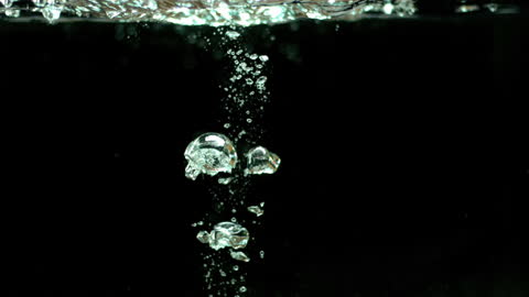 Tomato Splashing into Water with Rising Bubbles