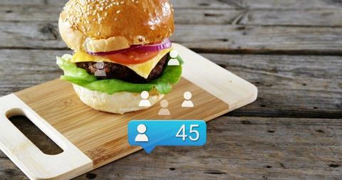 Gourmet sesame bun cheeseburger sitting on rustic cutting board with social media 45 badge