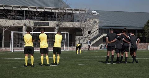 Soccer players preparing for penalty kick on field