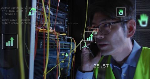 Technician in data center analyzing network infrastructure with smartphone